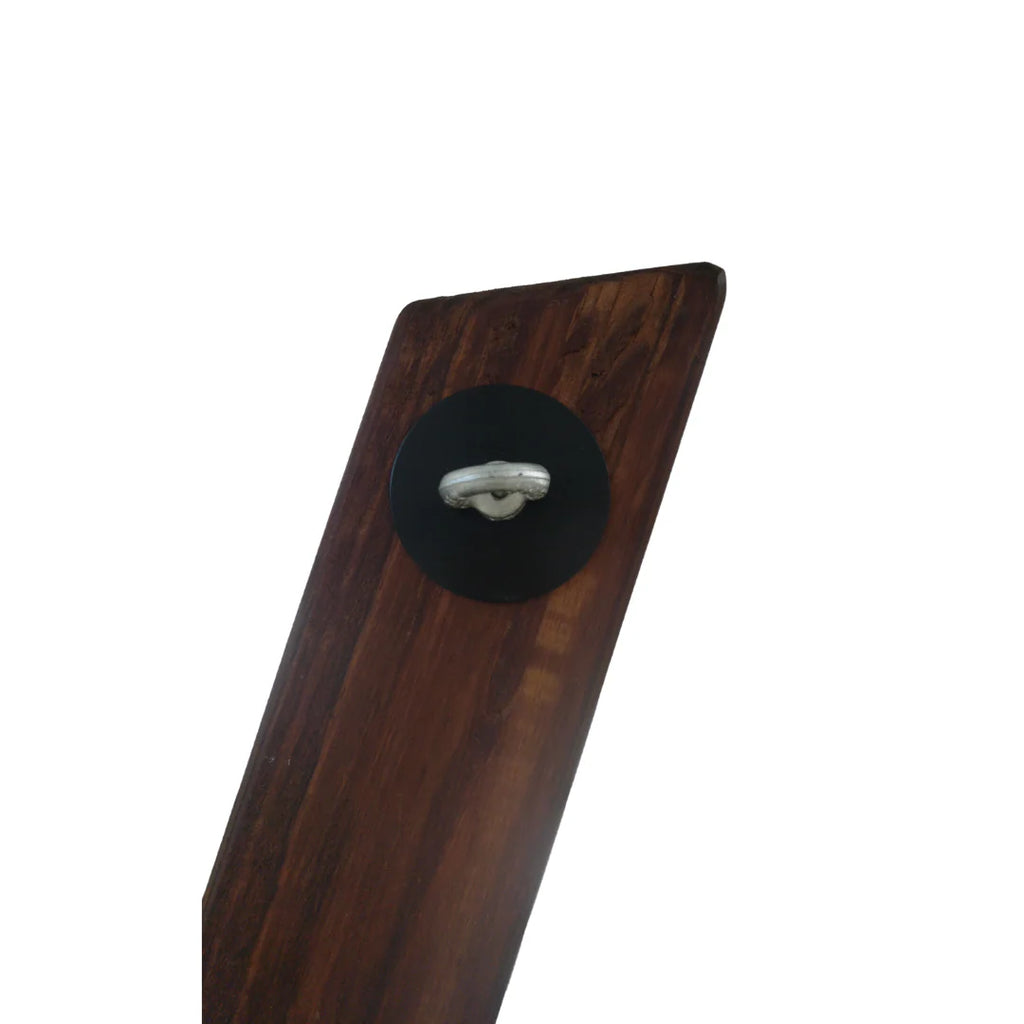 Close-up of metal restraint ring and mounting plate on wooden St. Andrew’s Cross
